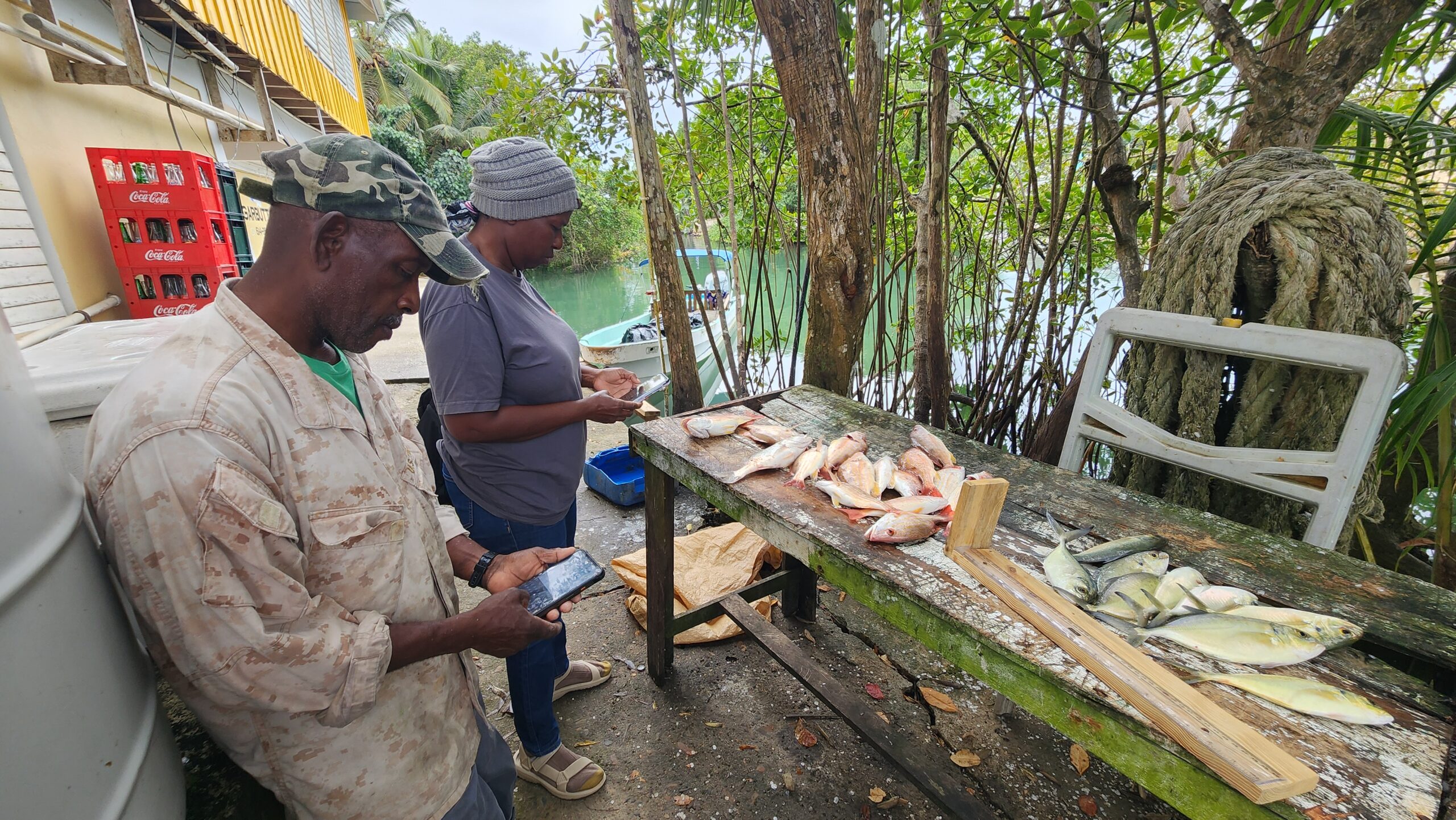 Two fishers monitoring and collecting data.