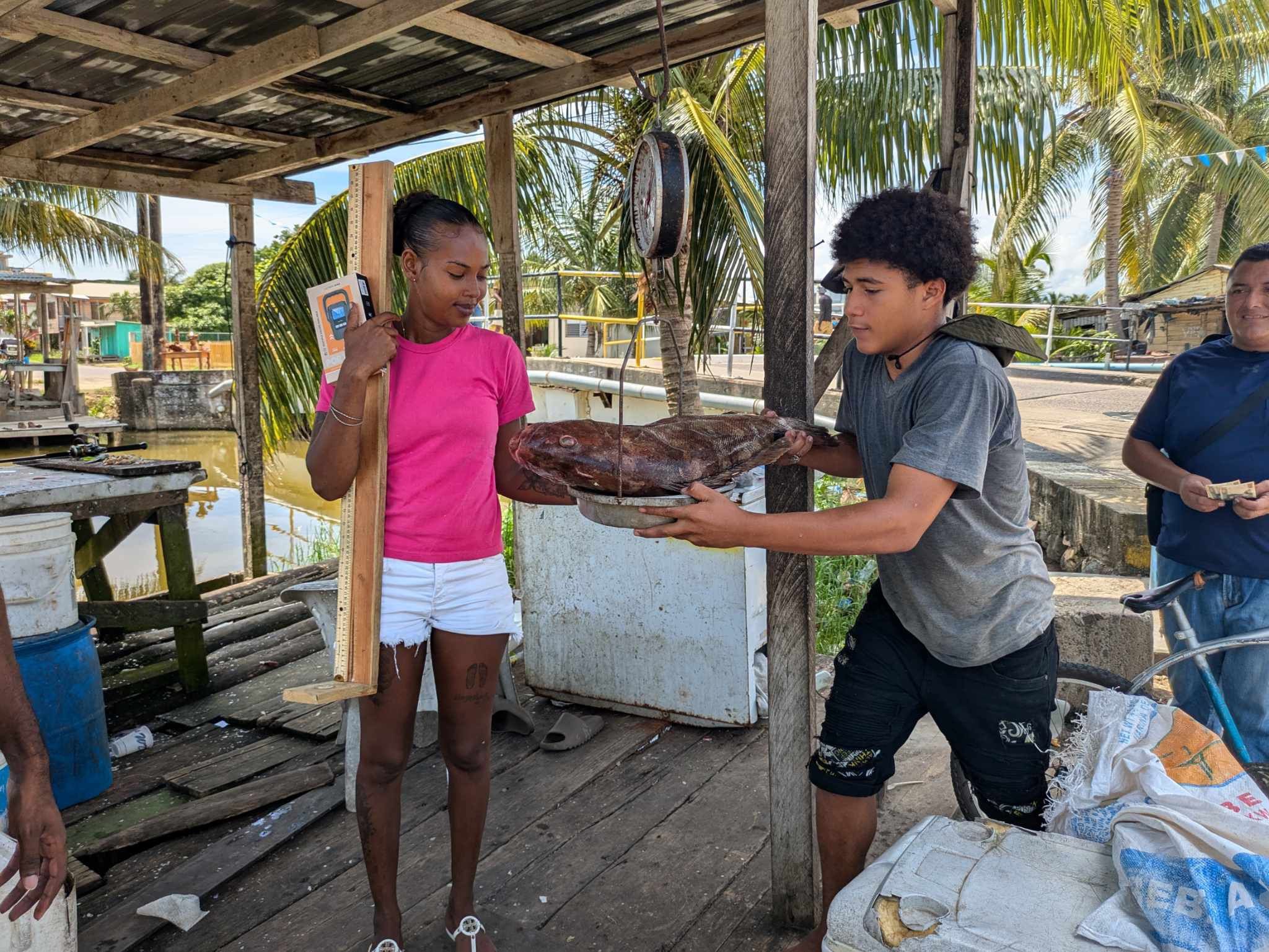 Two fishers recording their catch.