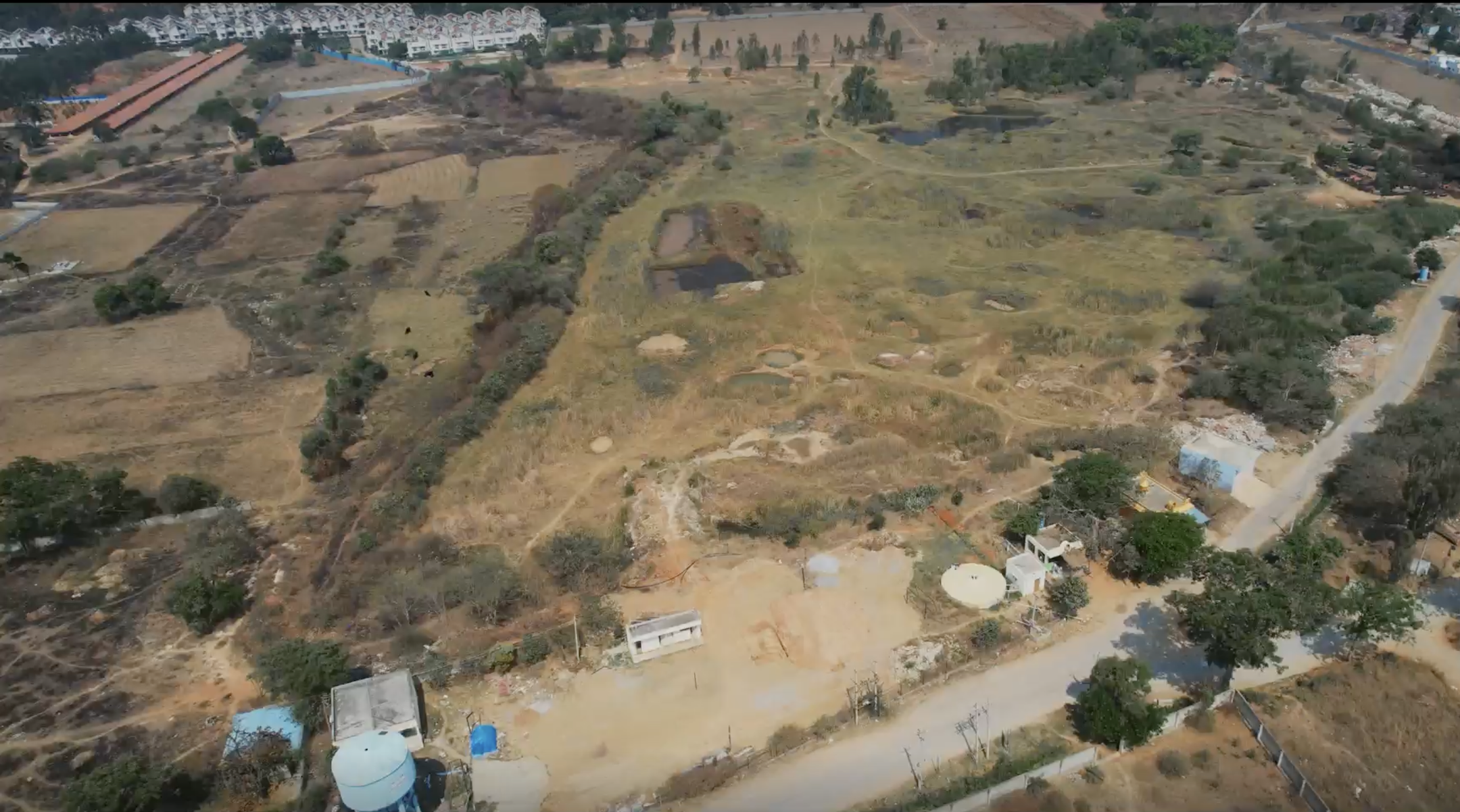 An aerial view of a dried-out, empty field.