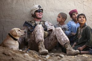 Soldier with children and dog.