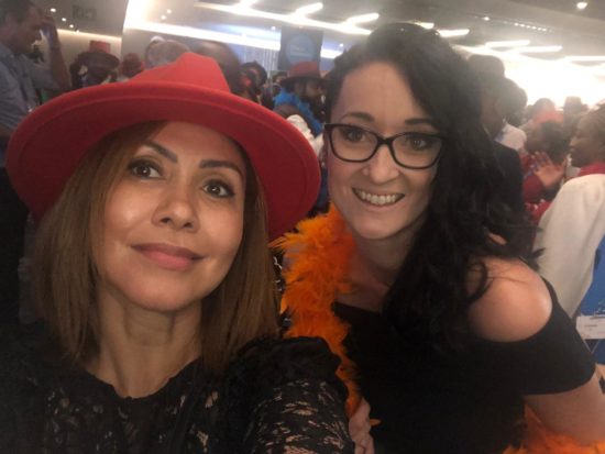 Corien and a friend smile at an event.